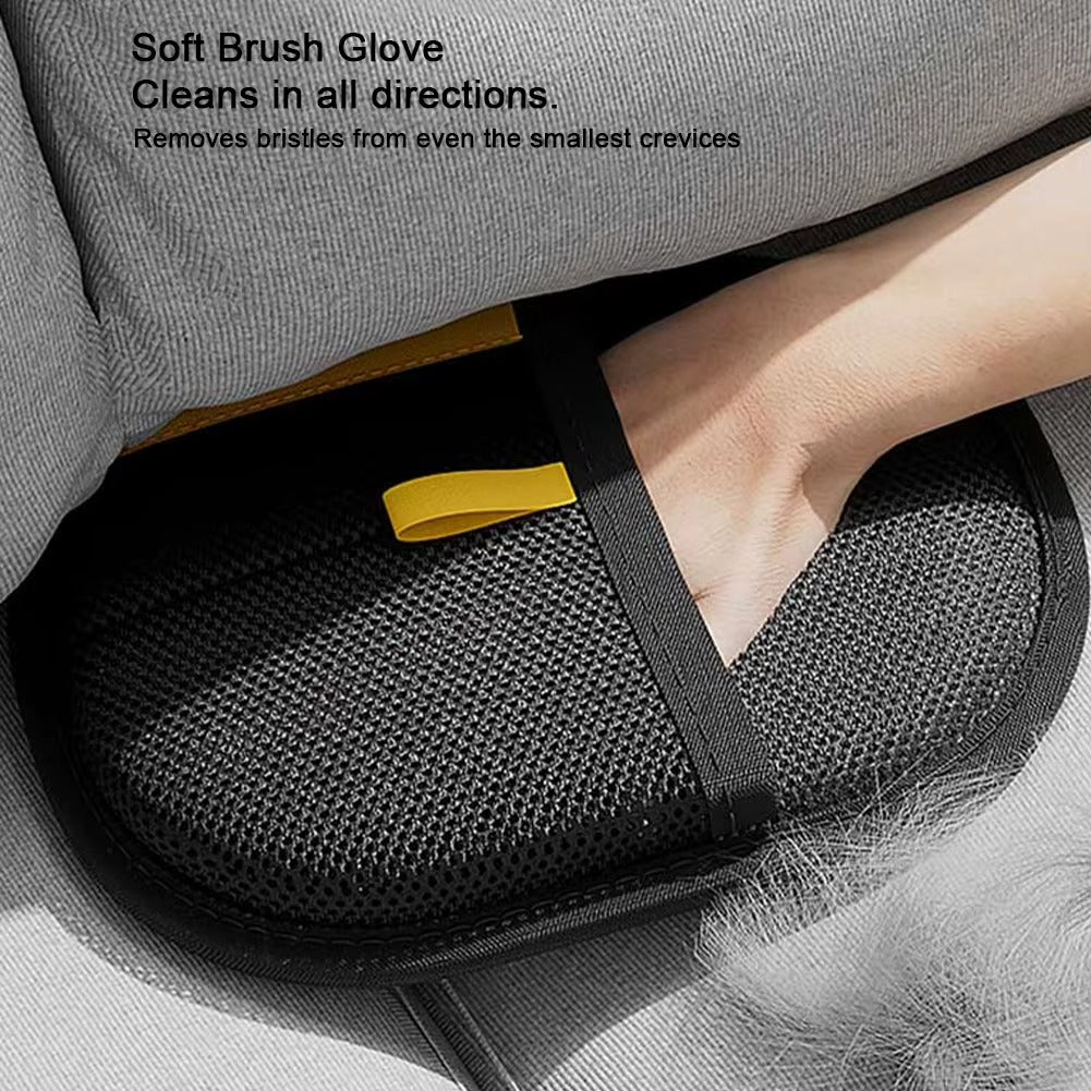 Gray soft brush glove with a yellow tag being used on a pet bed.